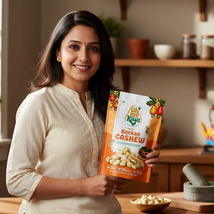 Oh my Kaju Konkan Cashew packaging on a wooden table with a blurred indoor background


