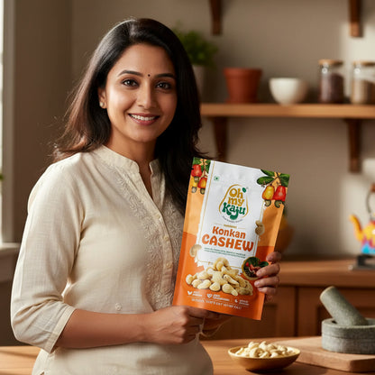 Oh my Kaju Konkan Cashew packaging on a wooden table with a blurred indoor background

