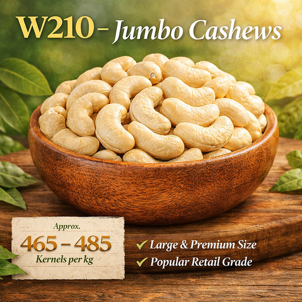Bowl of W210 Jumbo Cashews on a wooden surface with green leaves in the background
